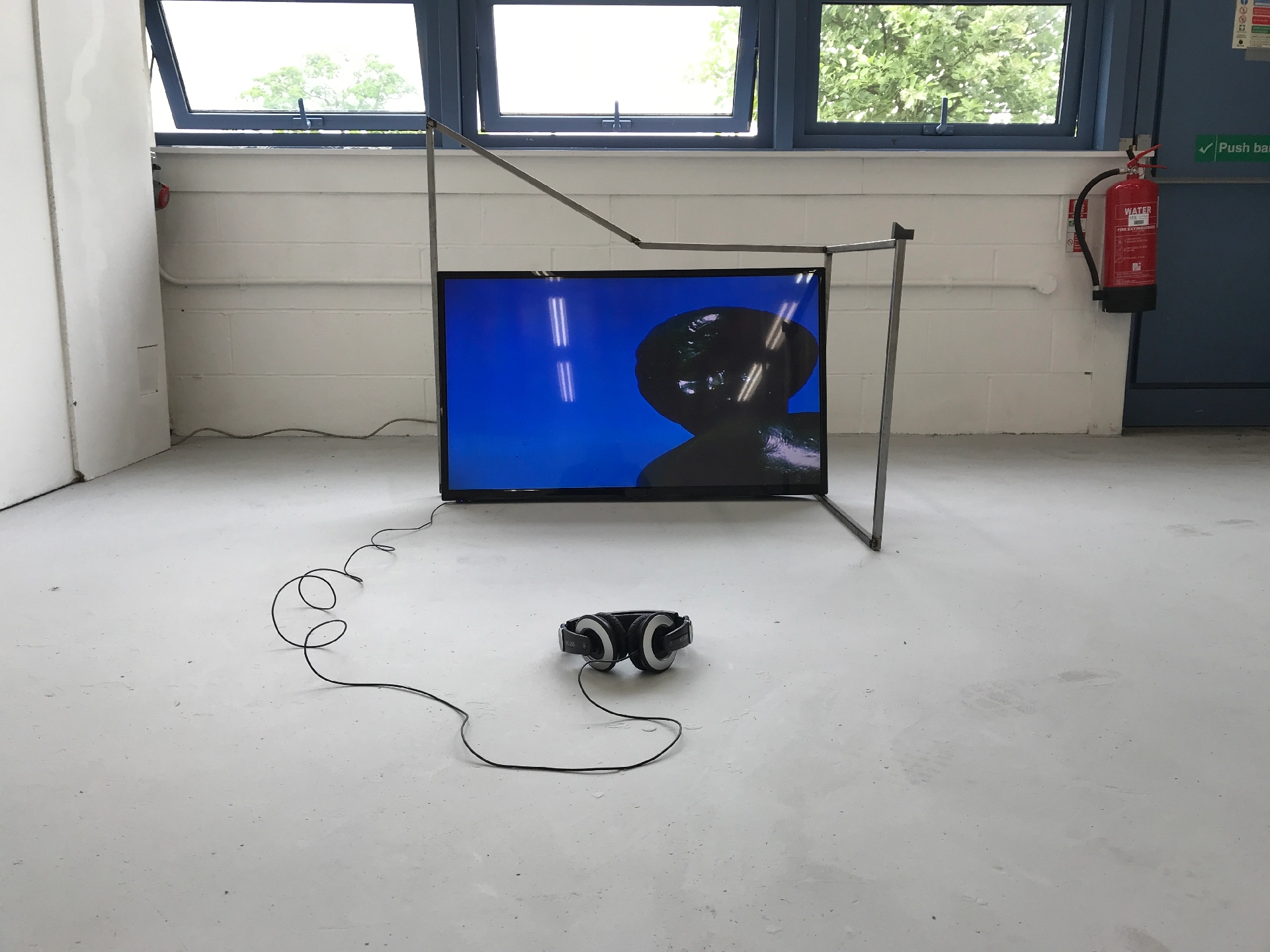 Single channel video. Duration: 06 minutes, 15 seconds. 25mm steel square-tube, TV, 3D printed SLS plastic, headphones