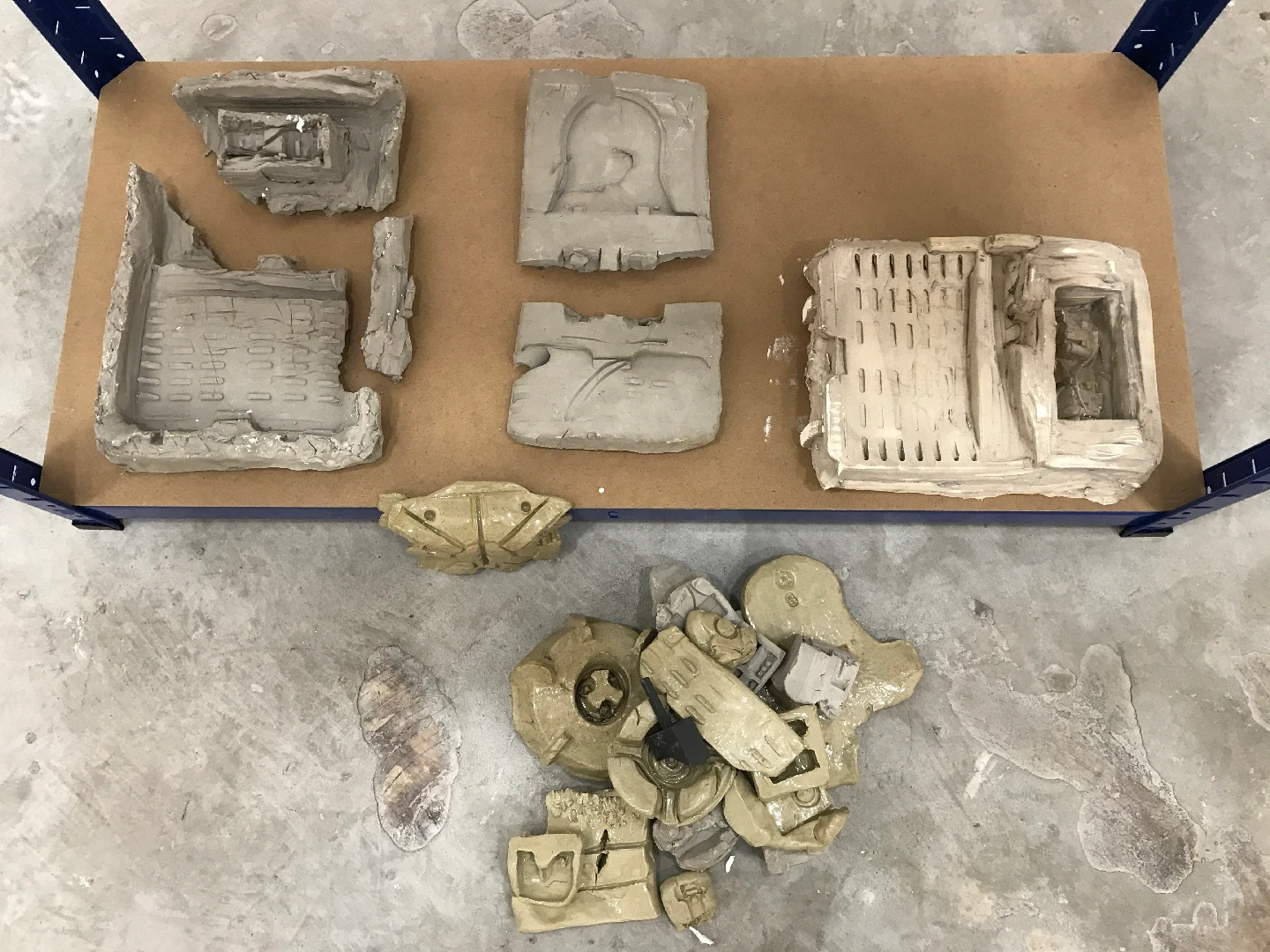 Glazed ceramic, unfired clay, 3D printed SLS plastic, shelving, found objects, plaster