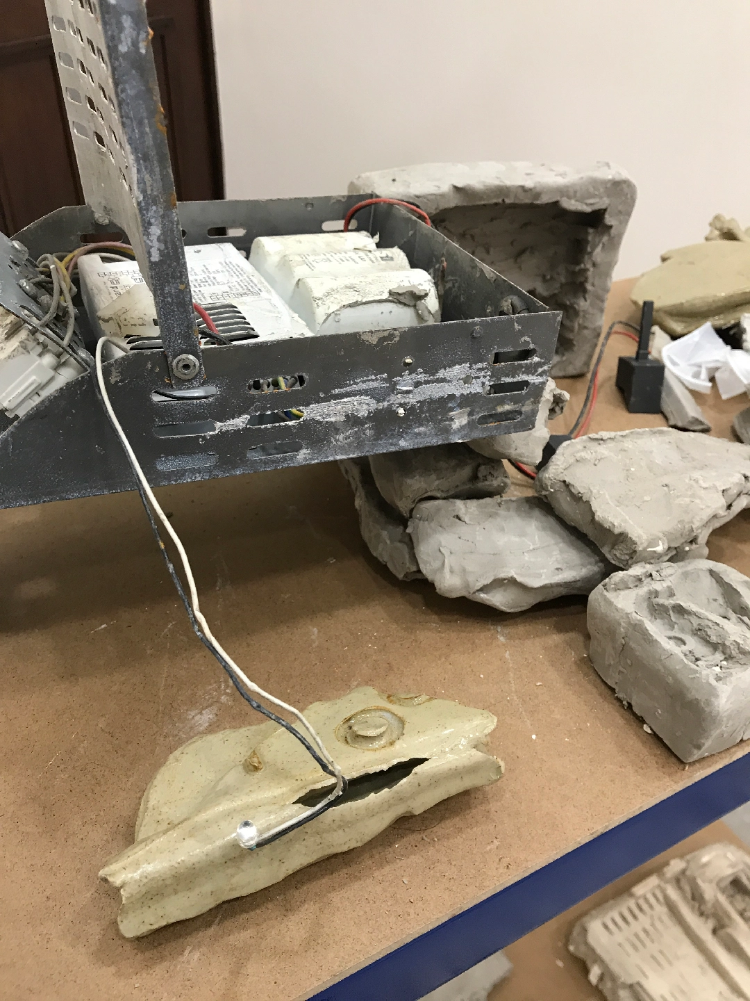 Glazed ceramic, unfired clay, 3D printed SLS plastic, shelving, found objects, plaster