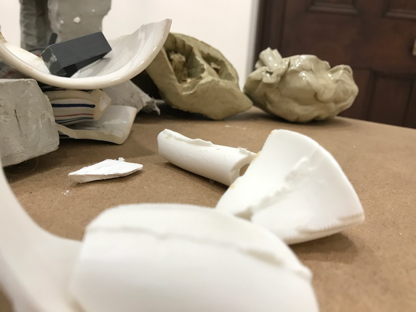 Glazed ceramic, unfired clay, 3D printed SLS plastic, shelving, found objects, plaster